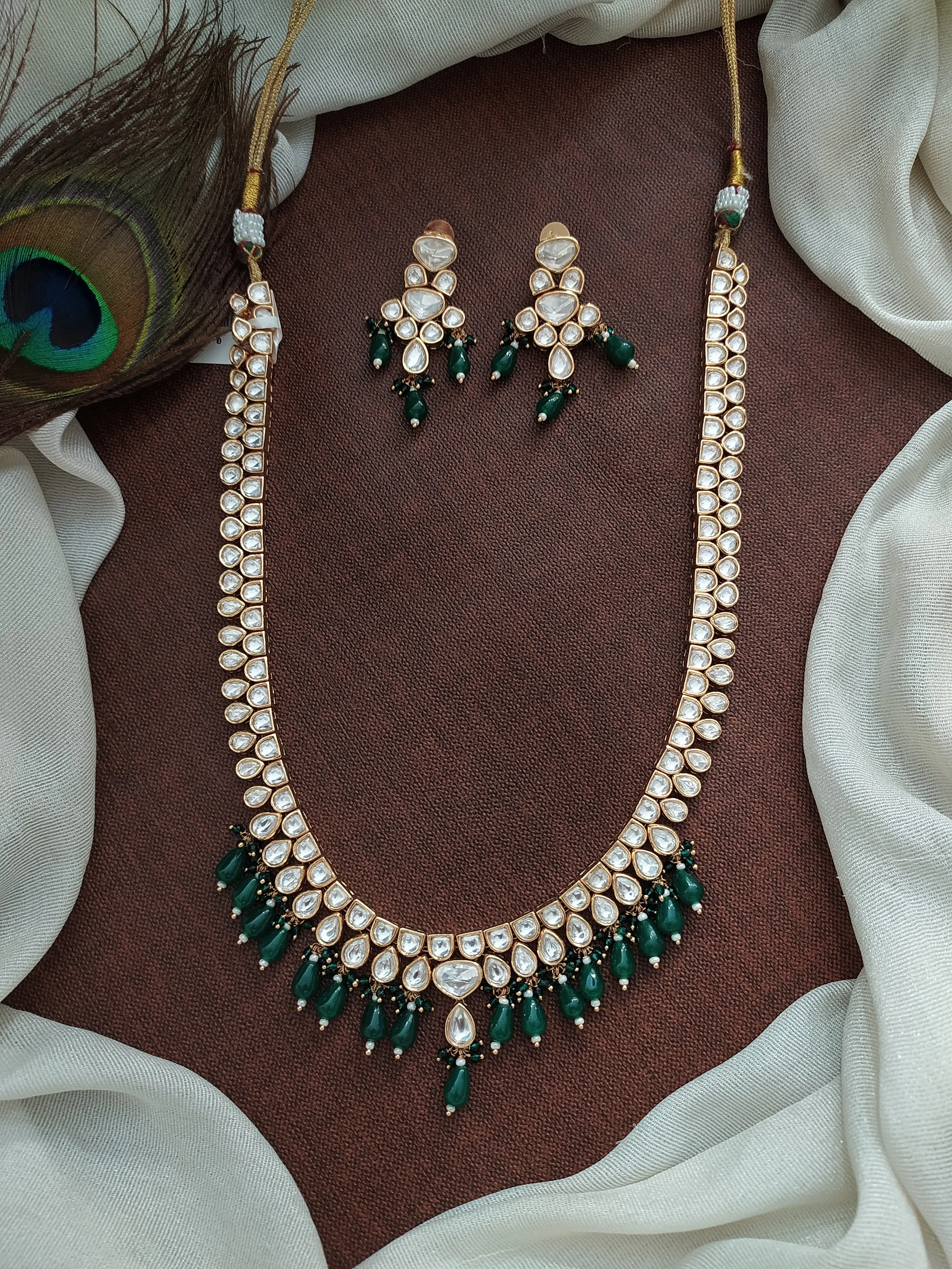 U-Shaped Kundan White Long Haram Set with Green Pear-Shaped Beads