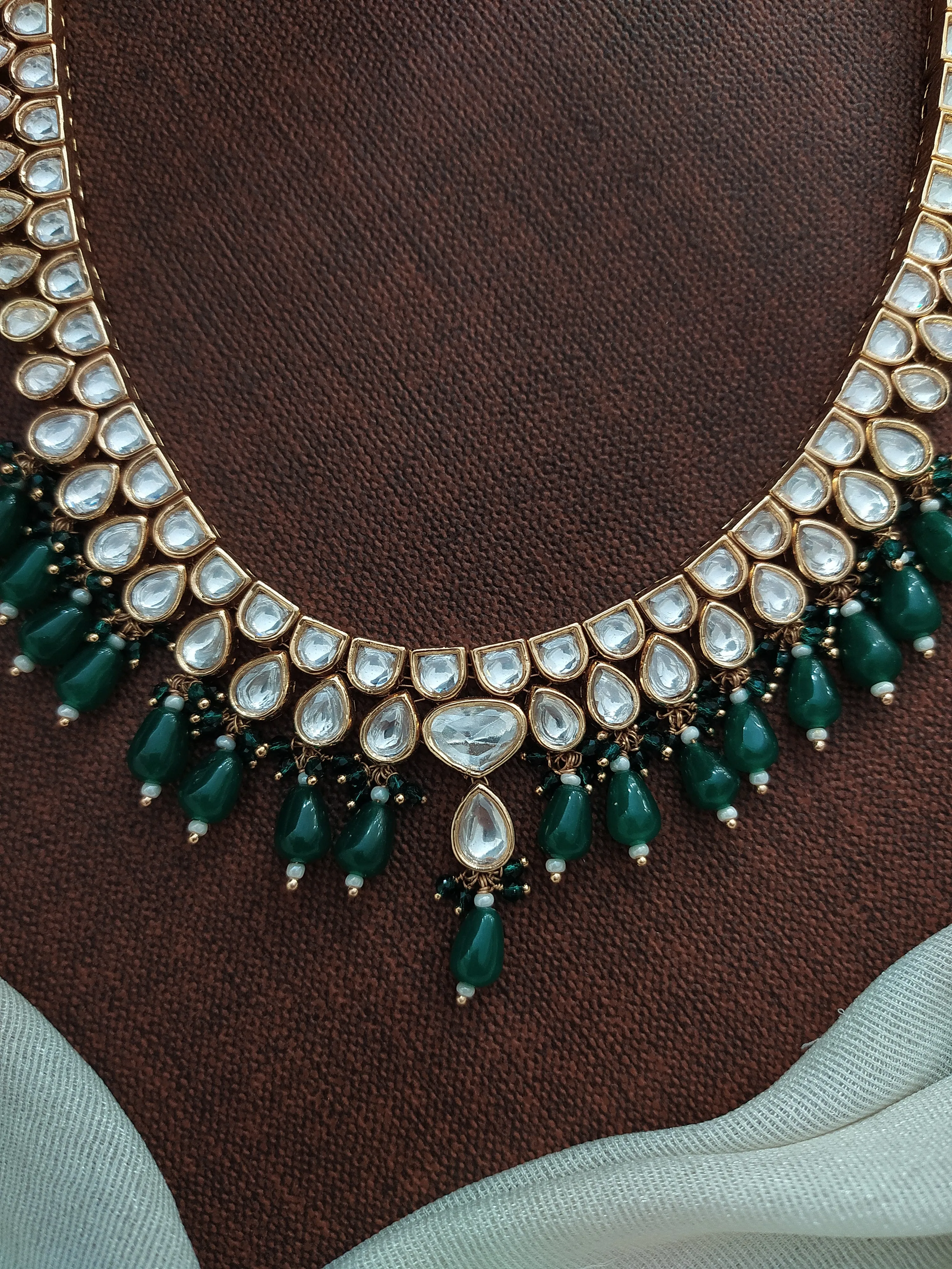 U-Shaped Kundan White Long Haram Set with Green Pear-Shaped Beads